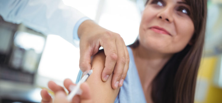 Doctor giving an injection to the patient at hospital